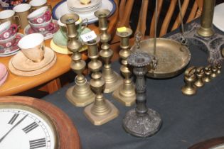 Two pairs of antique brass candlesticks and anothe