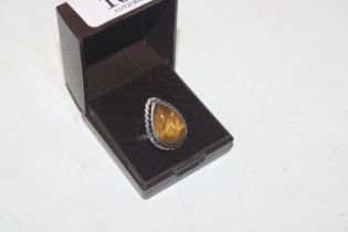 A white metal and tiger eye stone set ring
