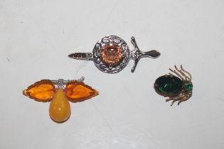 A brooch in the form of an insect set with green s
