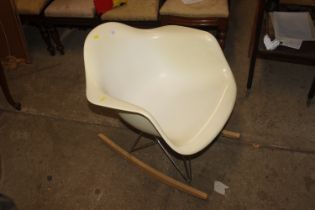 A Vitra Eames plastic rocking armchair