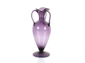 An Arts & Crafts style amethyst glass vase with fl