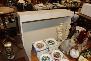 A white painted open fronted bookcase