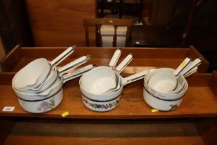 Nine French floral decorated saucepans