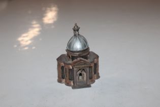 A silver architectural incense container with yell