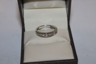 An 18ct white gold (marked rubbed) half eternity ring set with channel of ten diamonds totalling