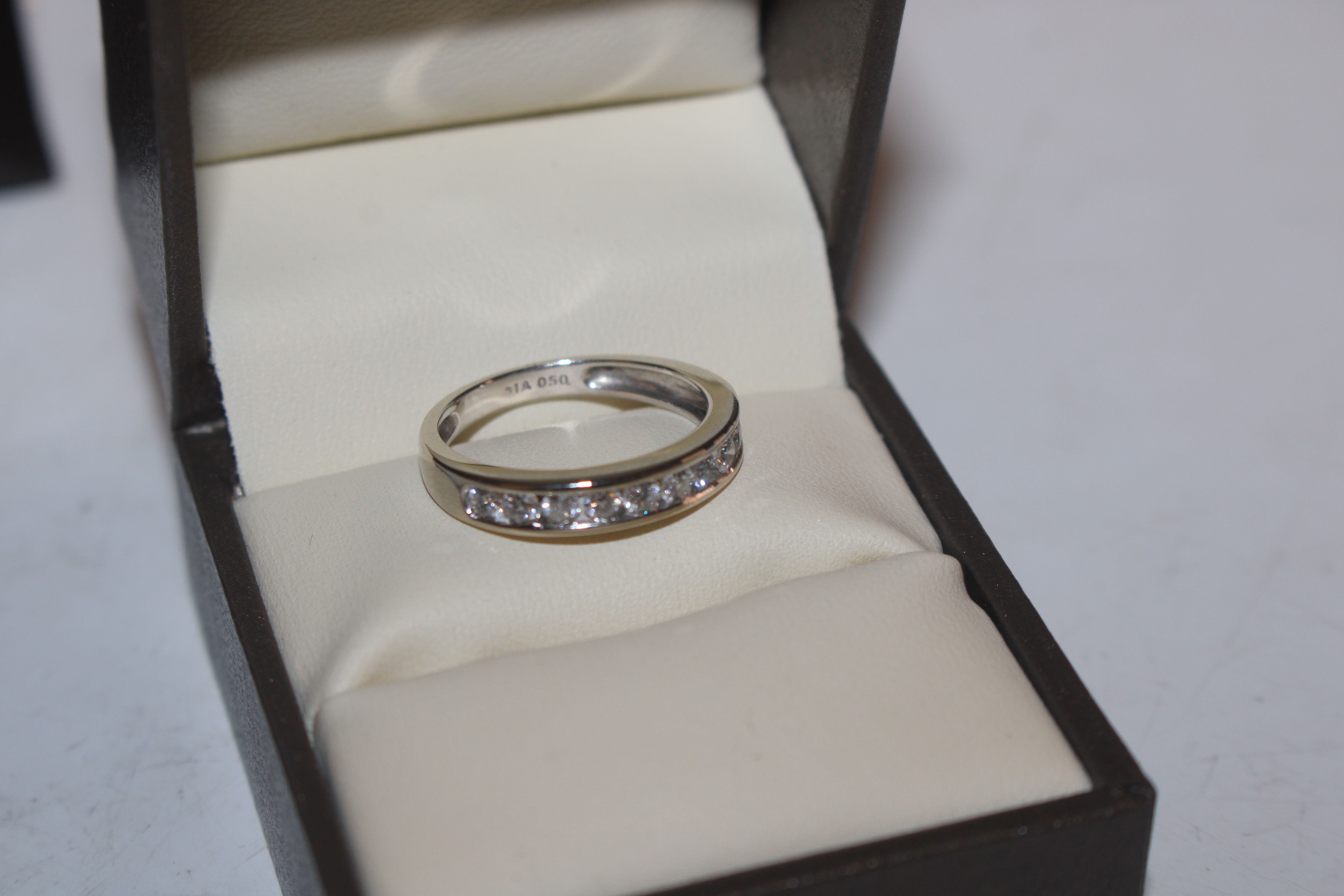 An 18ct white gold (marked rubbed) half eternity ring set with channel of ten diamonds totalling - Image 3 of 10