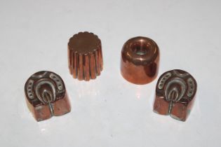 Two copper moulds in the form of horseshoes and two other moulds