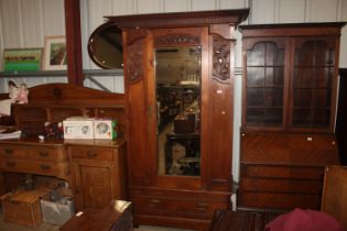 An Edwardian Art Nouveau style mahogany single mirror door wardrobe