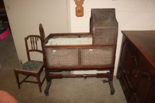 A Victorian mahogany crib having wicker sides and