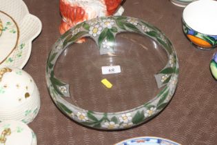 A clear glass bowl with painted decoration of flow