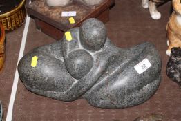 A sculpture in the form of stylised couple, signed