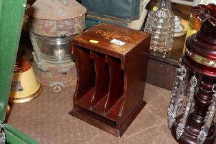 A mahogany and inlaid book rack of small proportio