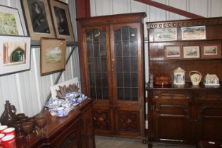 A 1930's oak and leaded glazed tall bookcase
