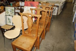 A set of four carved wooden colonial style dining