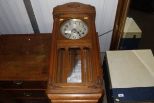 An early 20th Century oak cased chiming wall clock