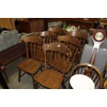 A set of six oak slat back dining chairs