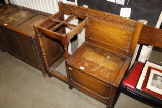 An oak hall seat with integral stick stand