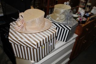 Two ladies hats and two striped hat boxes