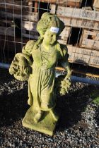 A concrete garden ornament in the form of a maiden