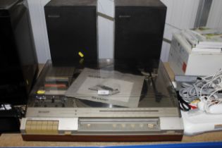 A Sharp receiver, cassette deck, and record [playe