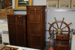 An oak linen fold decorated single wardrobe