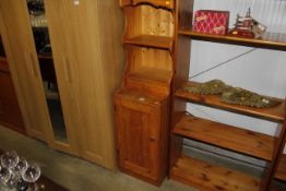 A narrow pine dresser with fitted shelves, drawer