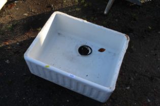 A wide ceramic butler style sink