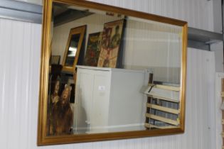 A large gilt framed bevel edged wall mirror