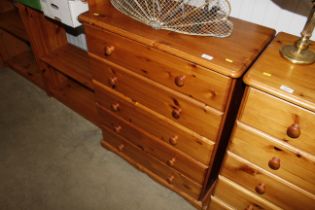A pine chest of five long drawers