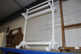 A white painted towel rail with barley twist colum