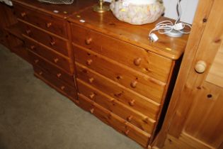 A pine chest of five long drawers