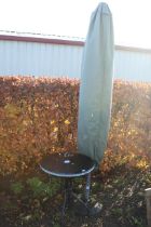 A black glass topped circular garden table, a gard