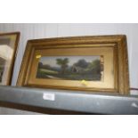 A small gilt framed oil on board of a cottage