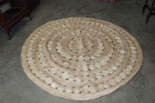 An approx. 6'10" diameter hessian rug