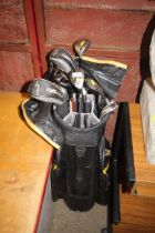 A quantity of various golf clubs to include woods,