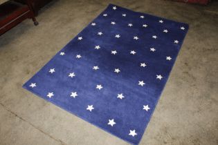 An approx. 6' x 4'1" blue ground rug with star dec