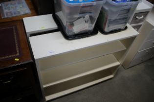 A pair of white painted open fronted bookcases