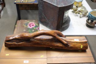 A carved wooden log ornament