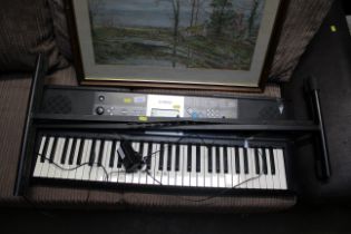 A Yamaha keyboard and folding stand