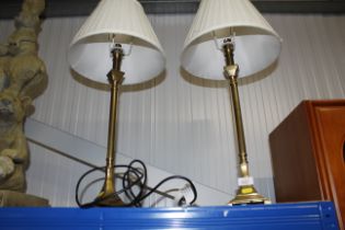 A pair of brass table lamps and shades