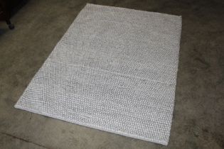 An approx. 5'6" x 4' pale knotted rug