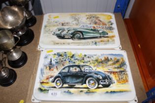 Two enamel signs depicting a Volkswagen Beetle and