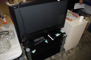 A Panasonic television; TV stand; Freeview box etc