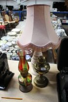 A brass oil lamp, a coloured glass similar and a tab