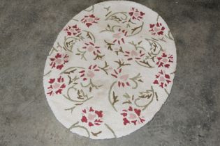 An approx. 3'5" x 2'7" floral patterned oval half