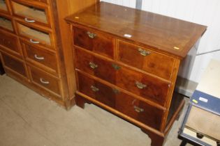 An antique walnut and herringbone banded chest of