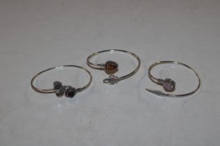 Three white metal and hardstone set bangles