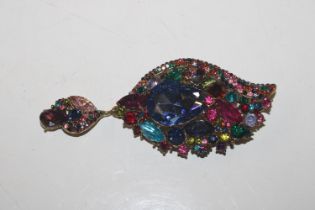 A pendant brooch set with multi coloured stones