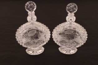 A pair of heavy crystal decanters with profuse hobnail pattern and fruit and foliage decoration; a