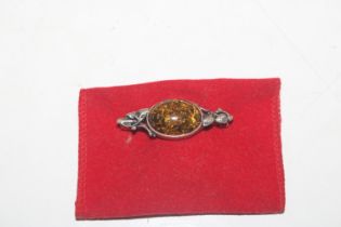 A vintage Sterling silver and amber brooch